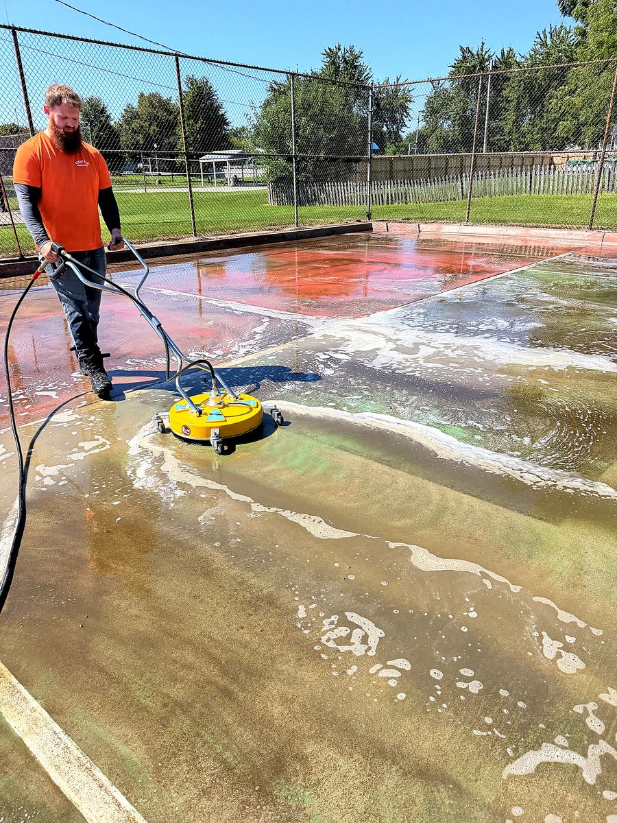 Pressure washing a court surface