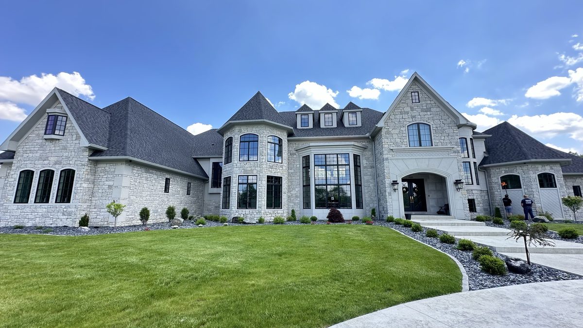 Crew on site at a stone estate home