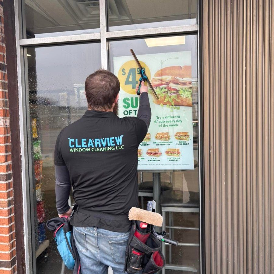 Crew member cleaning a storefront window