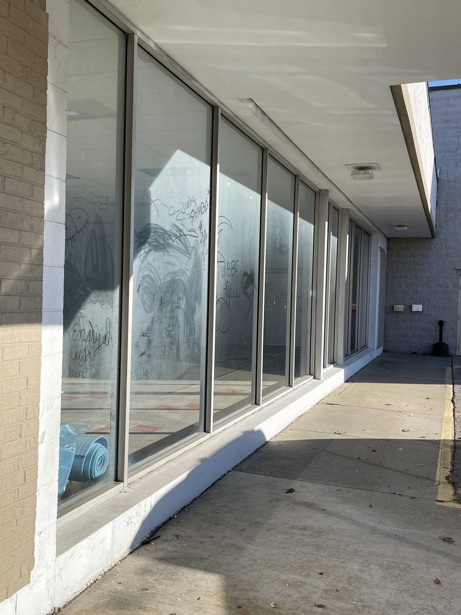 Storefront windows before cleaning, covered in dust and marks