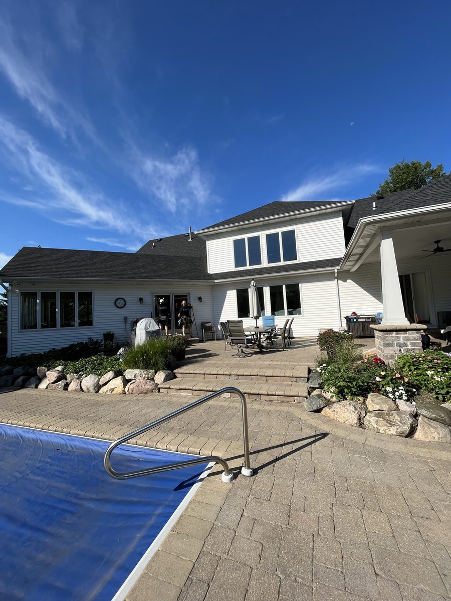 Crew working on a large home with a backyard pool
